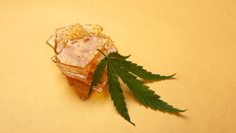 Marijuana leaf and wax showing an example of the best cannabis concentrates you can find. 